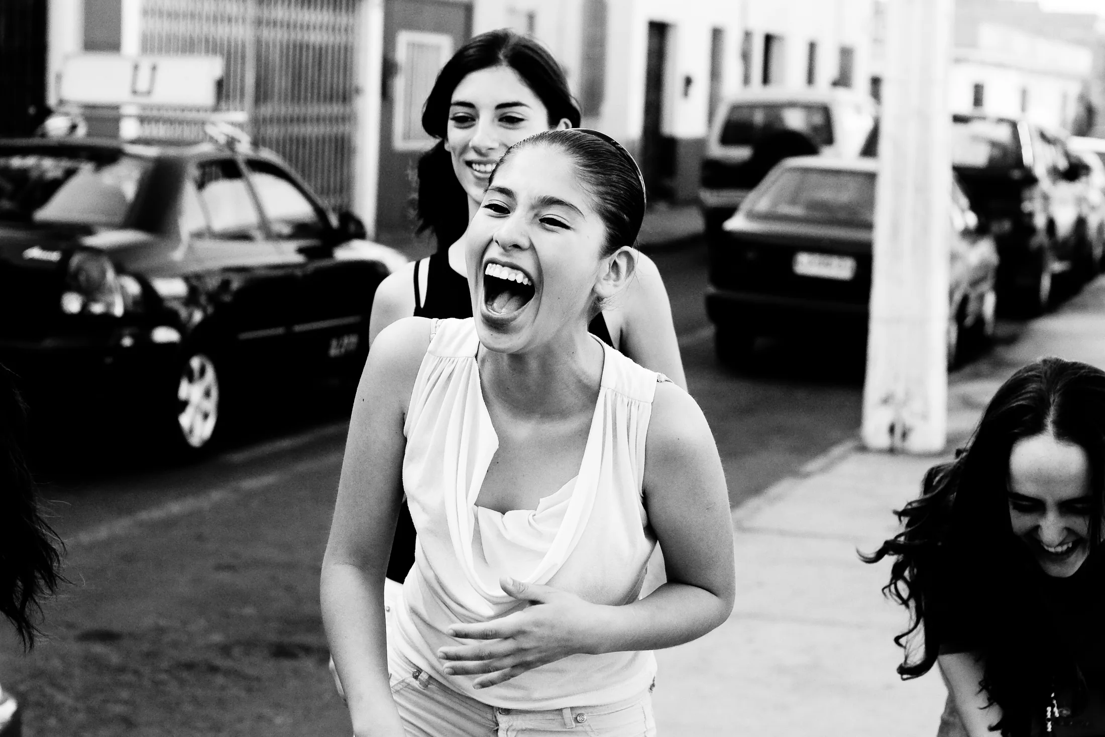 Three friends laughing outside after rehearsal in Arica