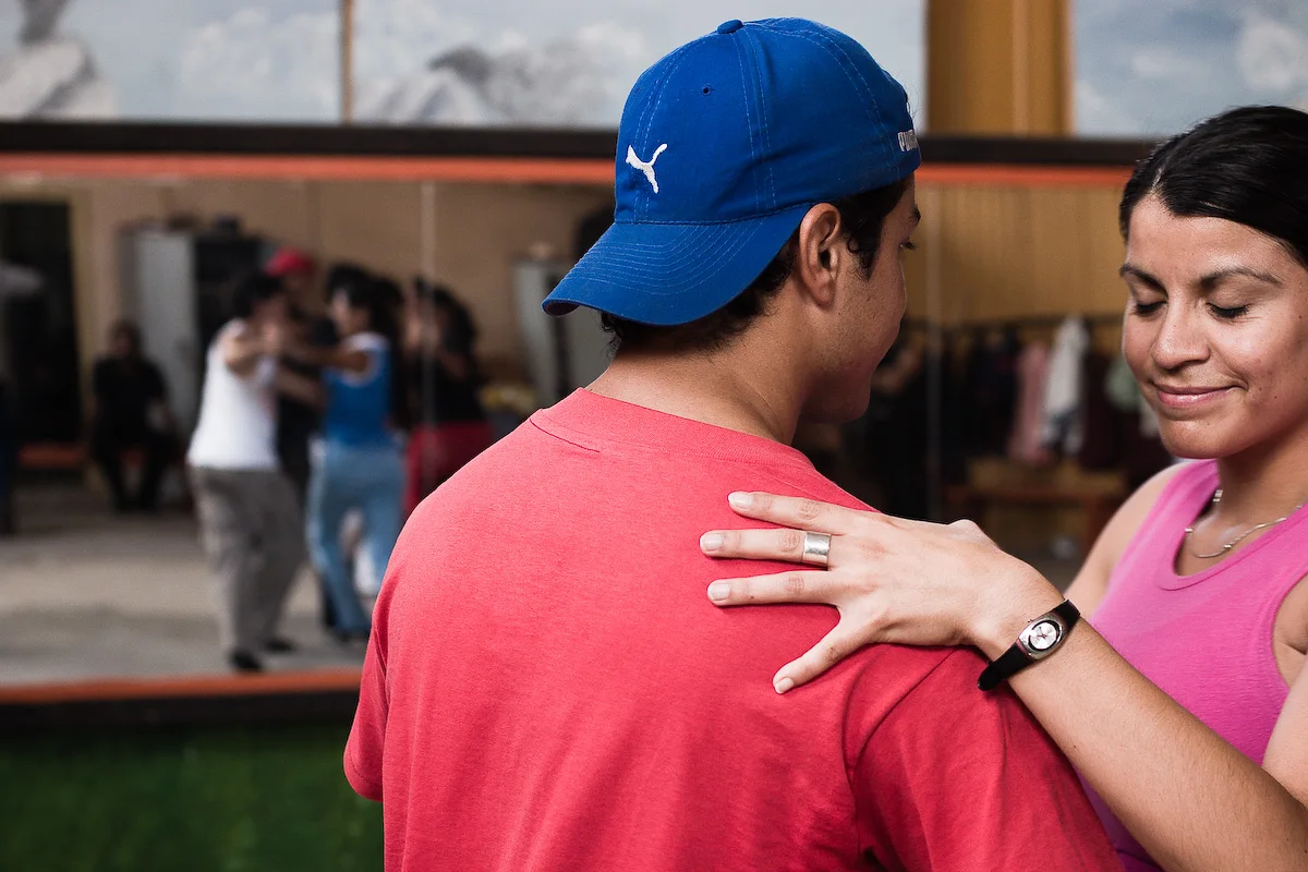 Two dancers practicing tango in a rehearsal hall in Arica