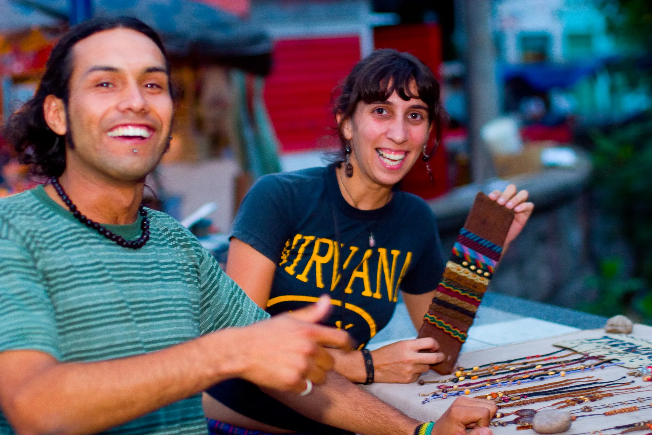 Two young artisans smiling at an evening market in San Salvador de Jujuy