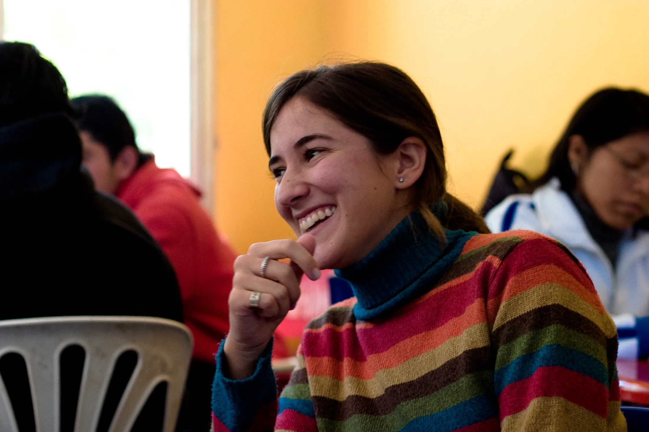 A young woman laughing during a gathering in Salta