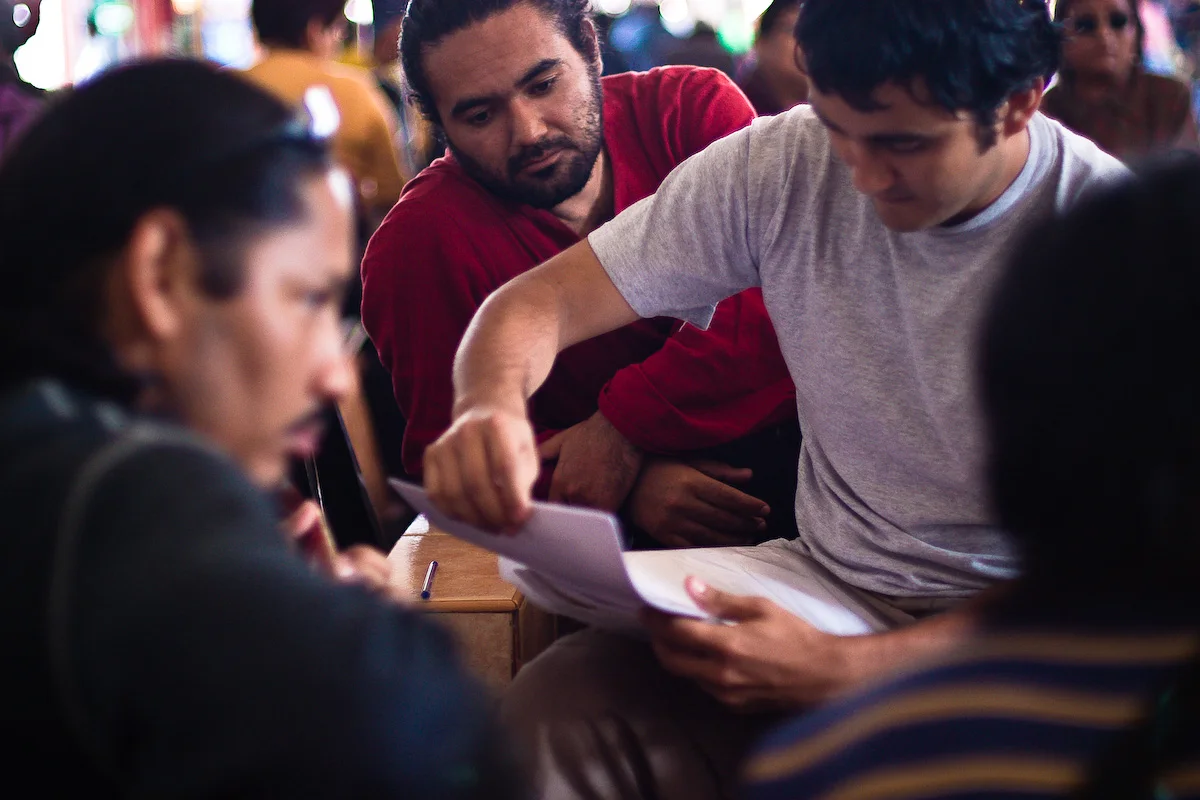 Los Danzares reviewing music together in the bus station at Tacna, Peru